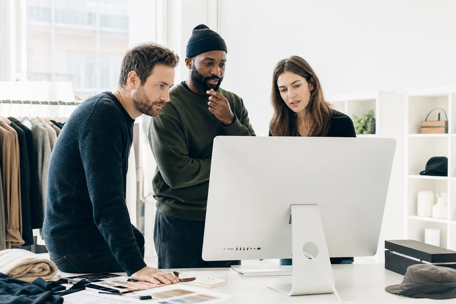 Product team reviewing a headless storefront concept in a bright studio